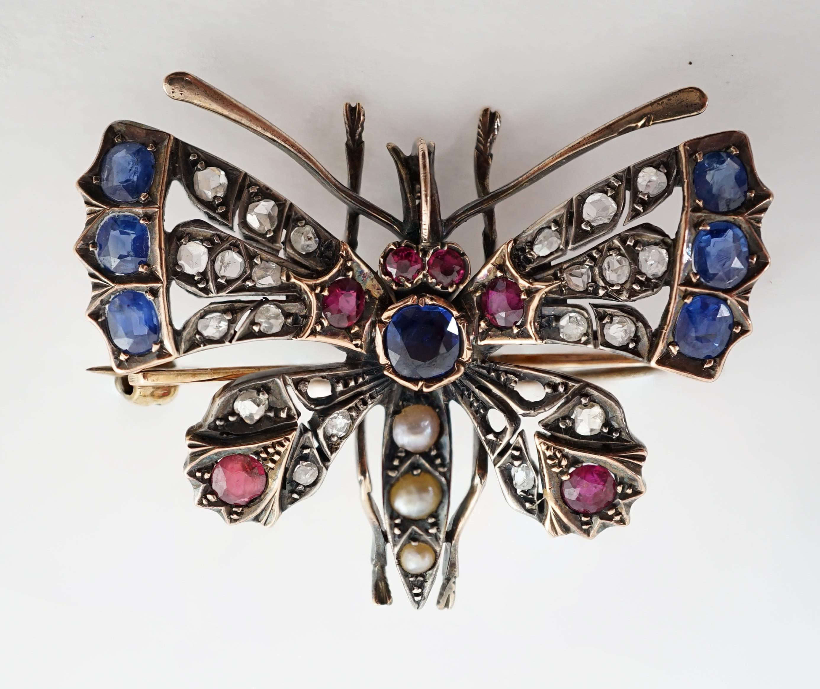 A Victorian gold, diamond, sapphire, ruby and split pearl cluster set butterfly brooch